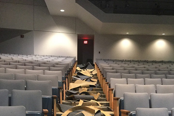 Removal of the old carpeting in the auditorium